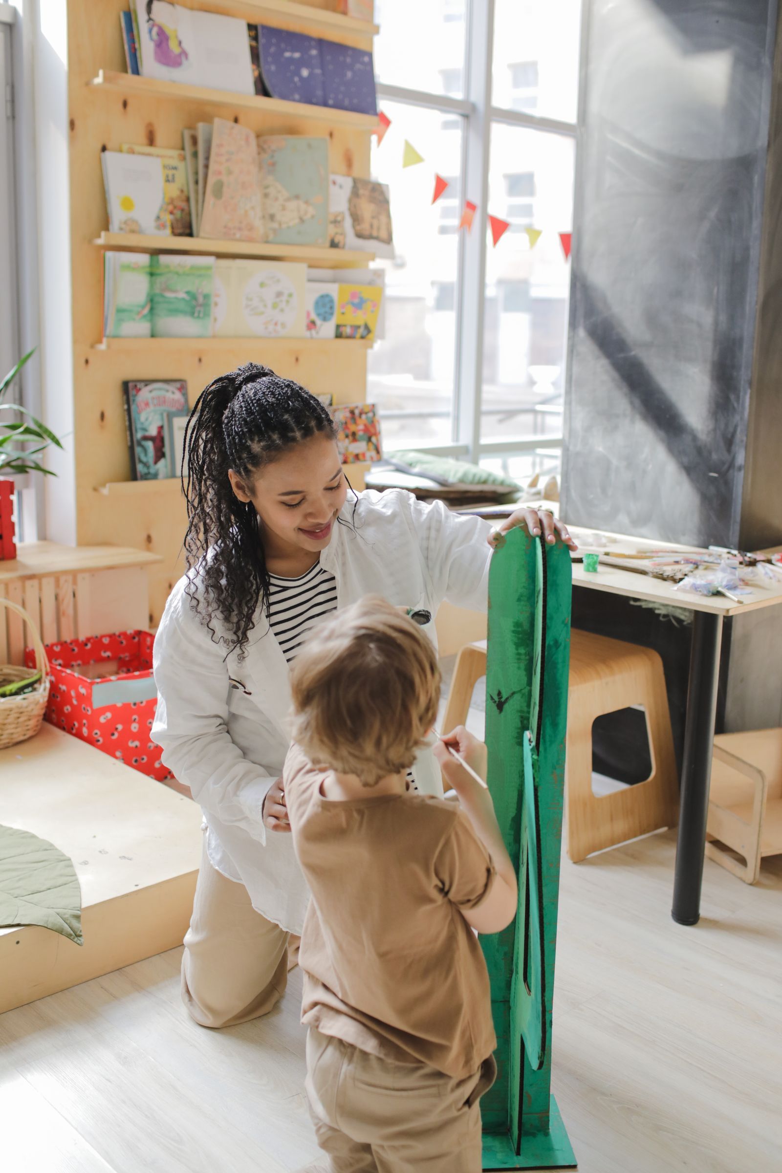 A caregiver reading one-on-one with a young child